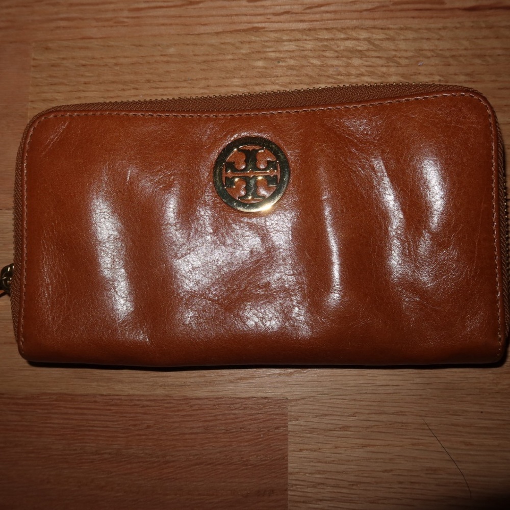 Tory Burch brown leather wallet with gold hardware.